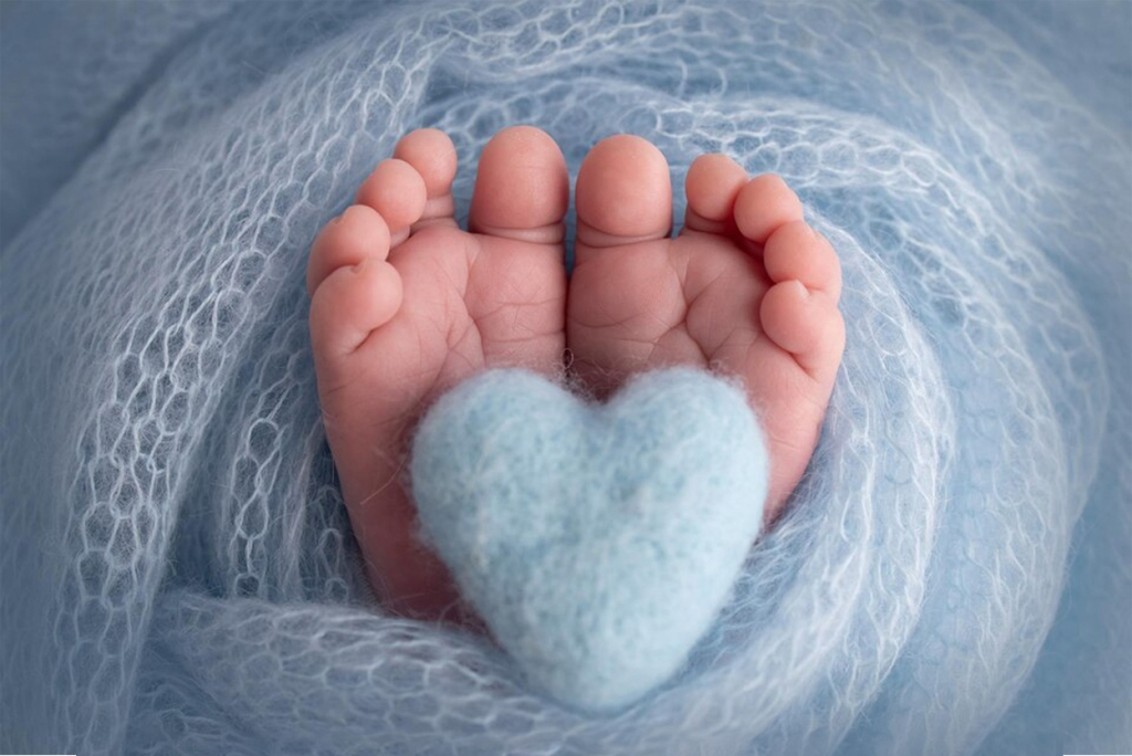 Baby feet with blue heart.