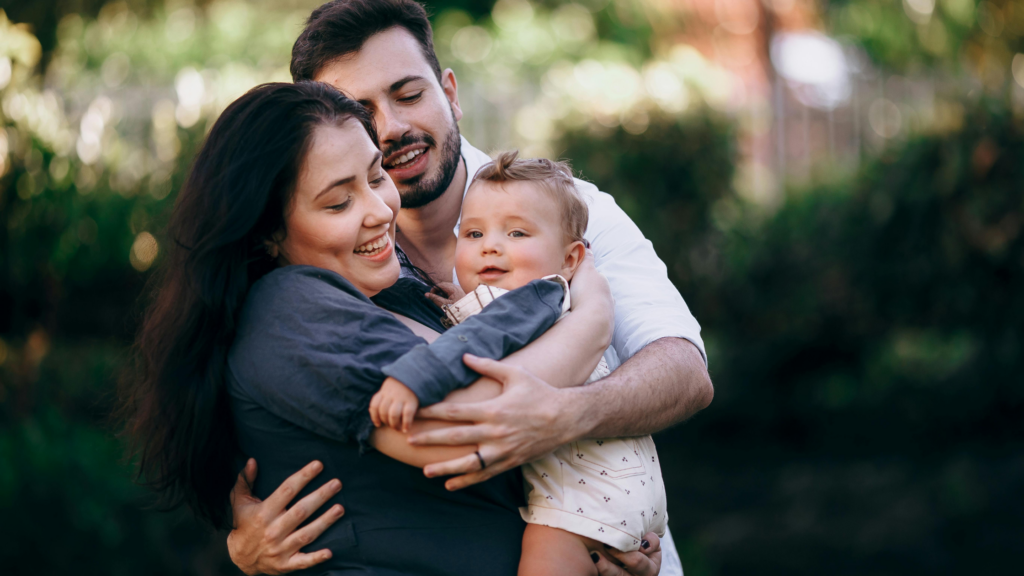 married couple holding baby