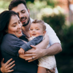 married couple holding baby
