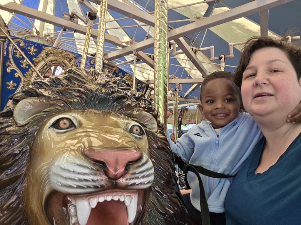 wyatt and stephanie with carousel lion.